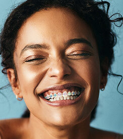 Girl wearing popular braces colors: pink and blue